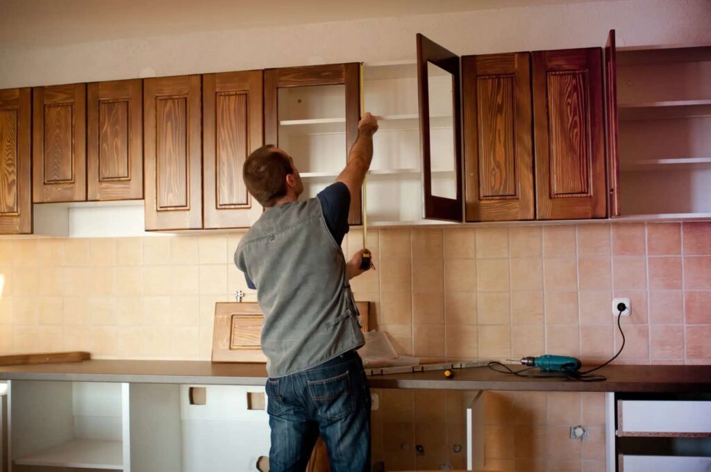 Dublin carpenter installing bespoke kitchen cabinets in a modern home