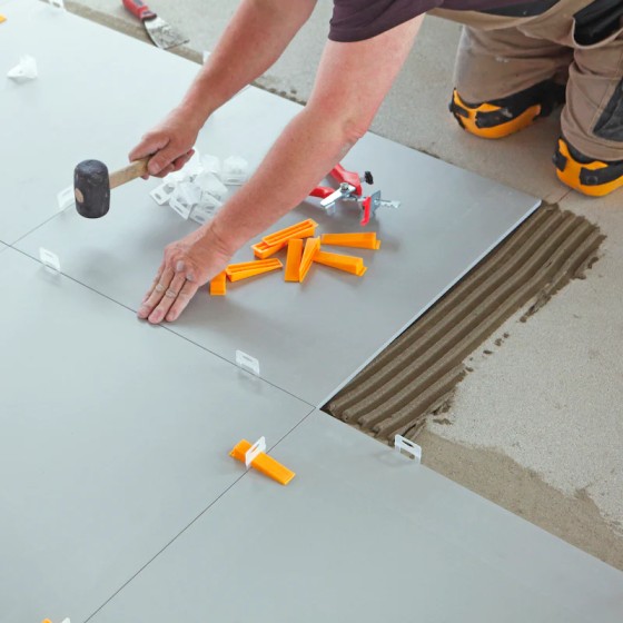 Professional tiler installing office floor tiles in Dublin