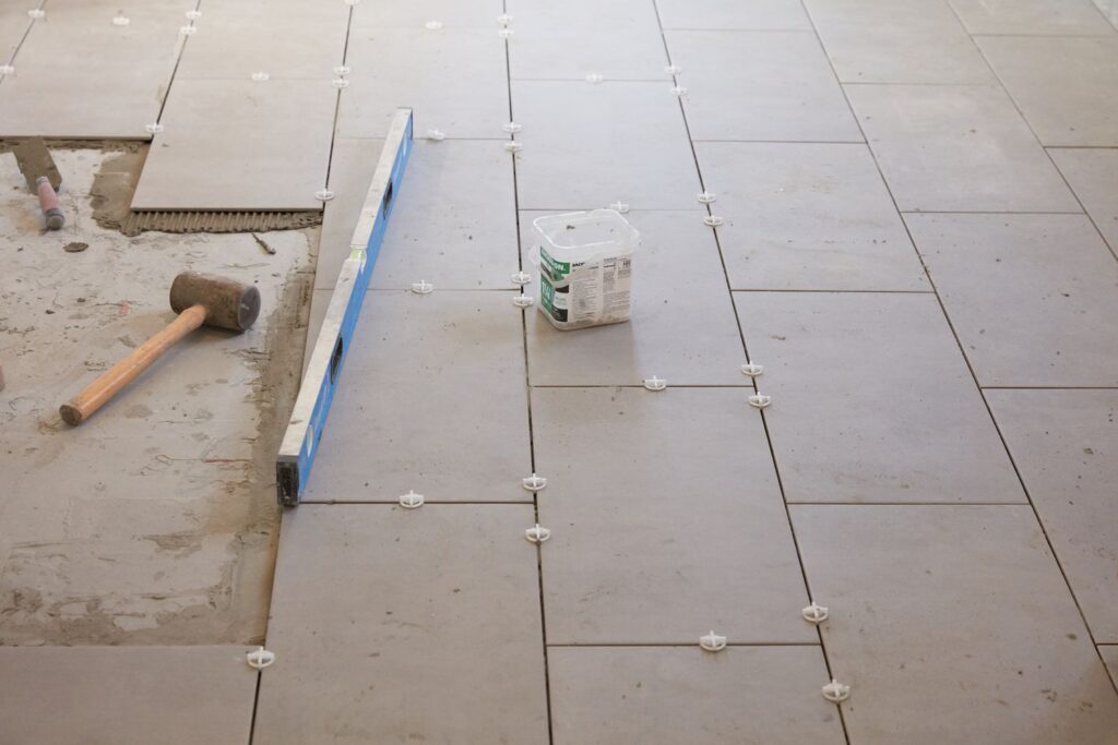 Professional tiler installing floor tiles in Dublin home