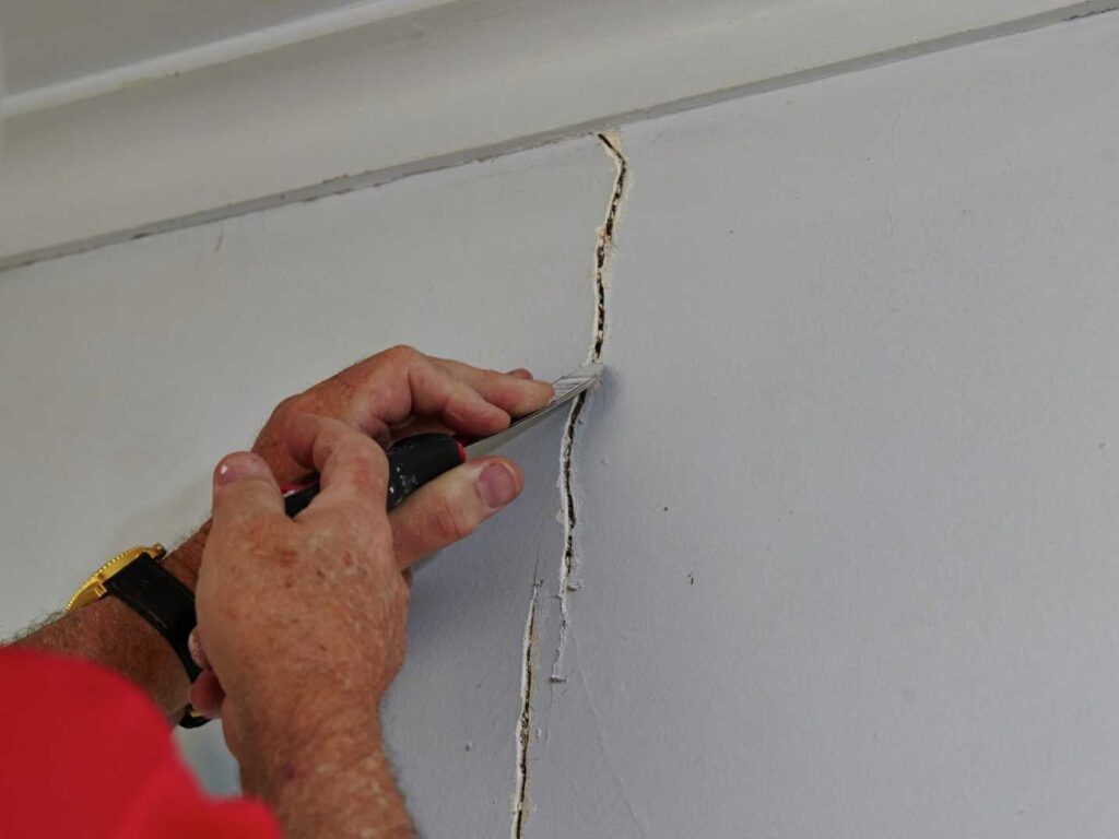 Plasterer repairing a wall crack in a Dublin home