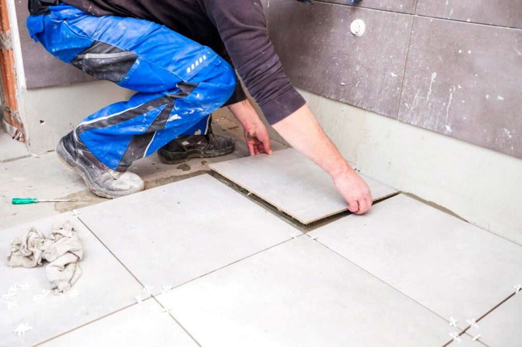 Professional tiler installing bathroom wall tiles in Dublin home