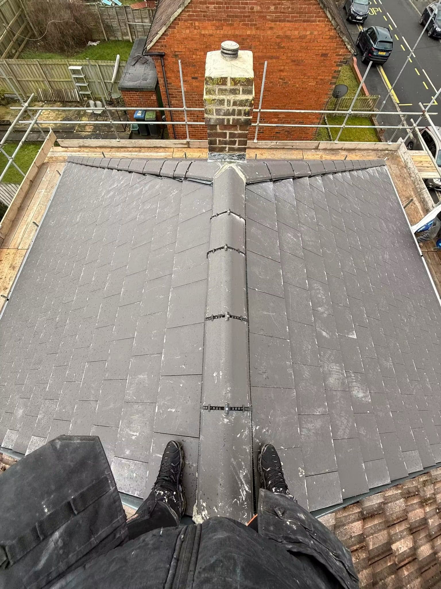 Finished slate roof with a new ridge, looking towards the chimney