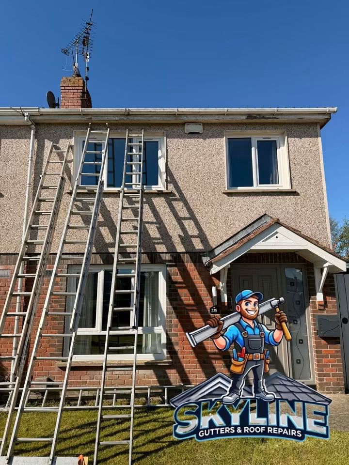 Semi-detached house with ladders up at the start of a fascia and gutter job