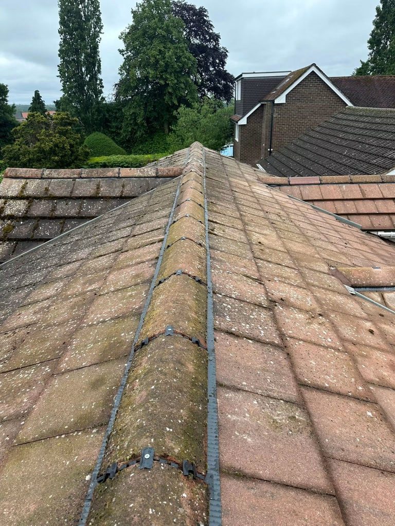 Two hips meeting at the top of a tiled roof, both fitted with dry ridge